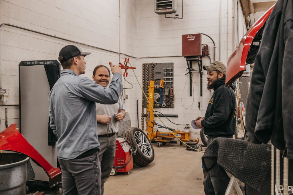 collision shop technicians chatting