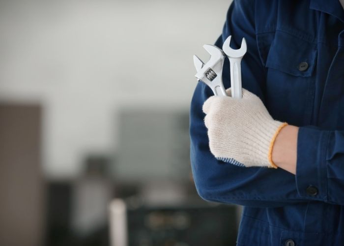 man handling two open wrench