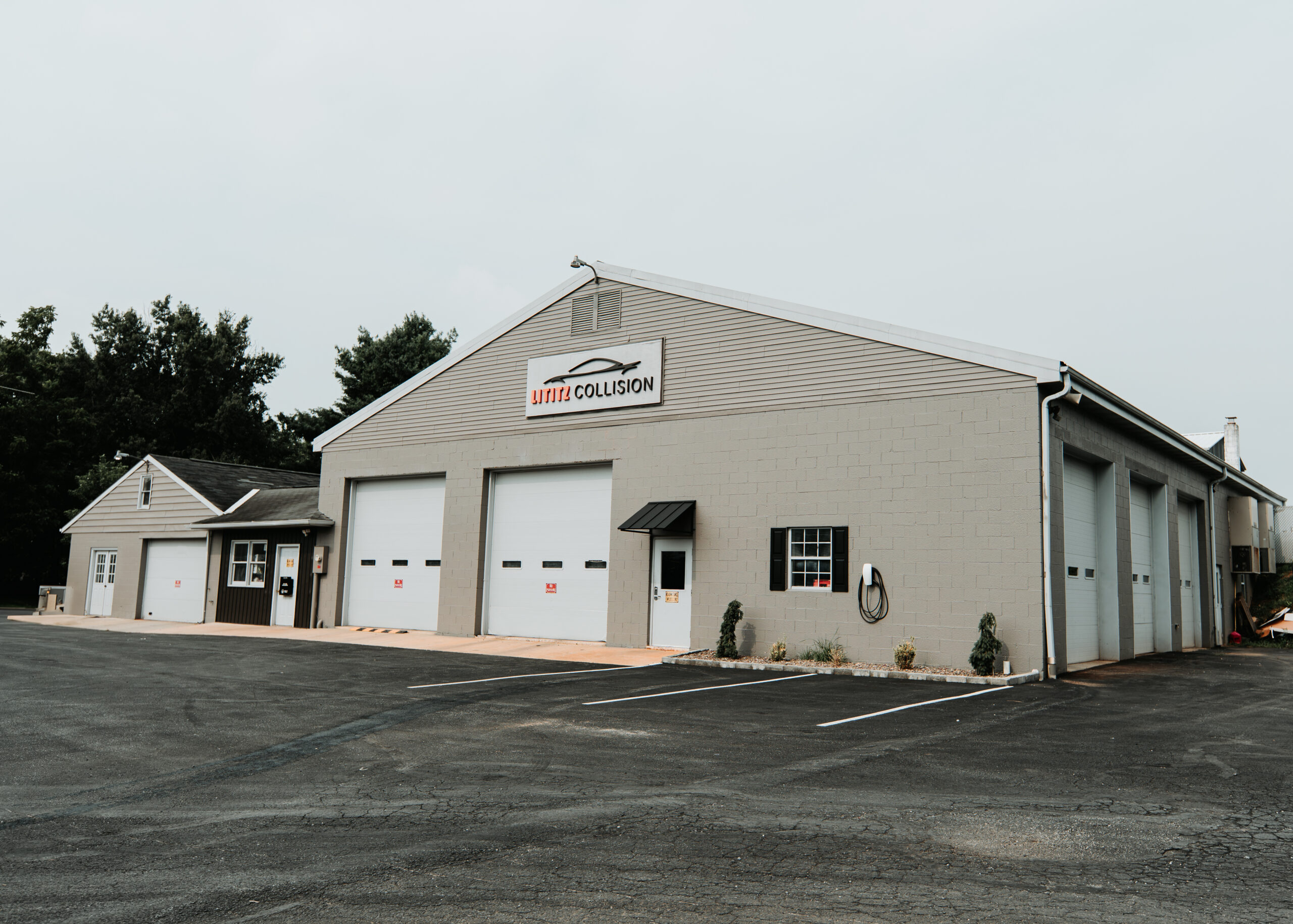 Lititz Collision repair facility exterior with multiple garage bays and signage.